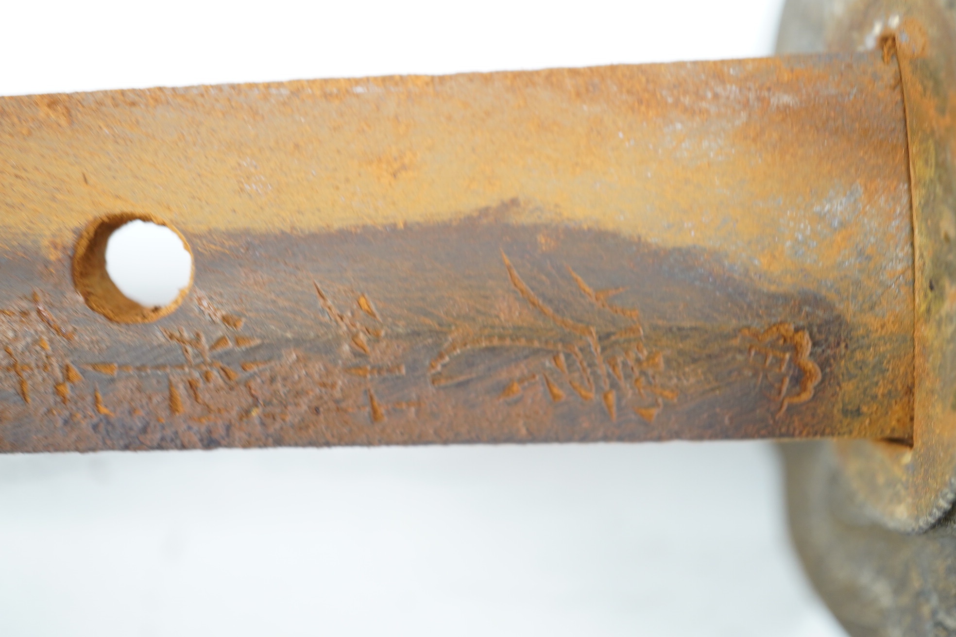 A WWII Japanese army officer’s Shingunto sword katana, blade 66.4cm, signed with Showa to stamp (tip of blade damaged), with unusual brass mounts, in its leather covered combat scabbard. Condition - poor to fair